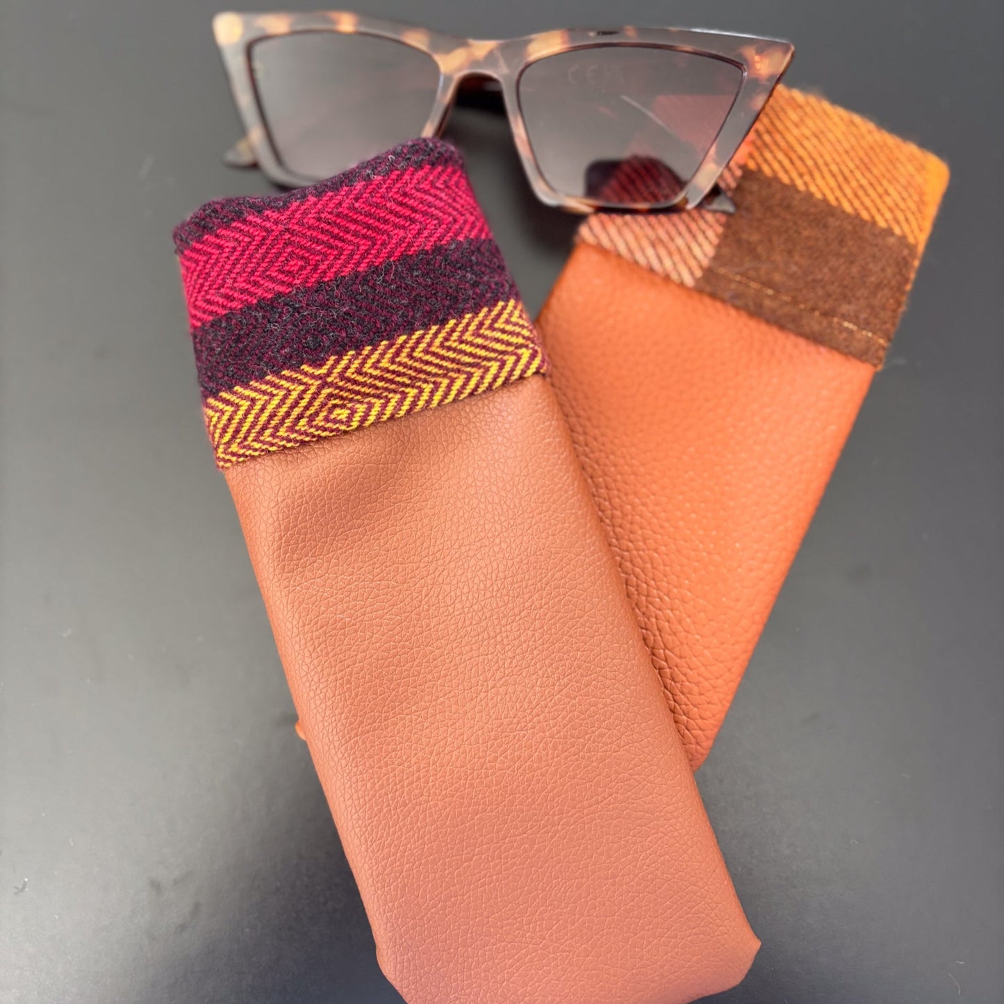 Glasses with colorful fabric case on a gray background