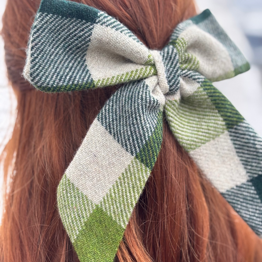 Checkered Tweed hair bow on red hair with a blurred background