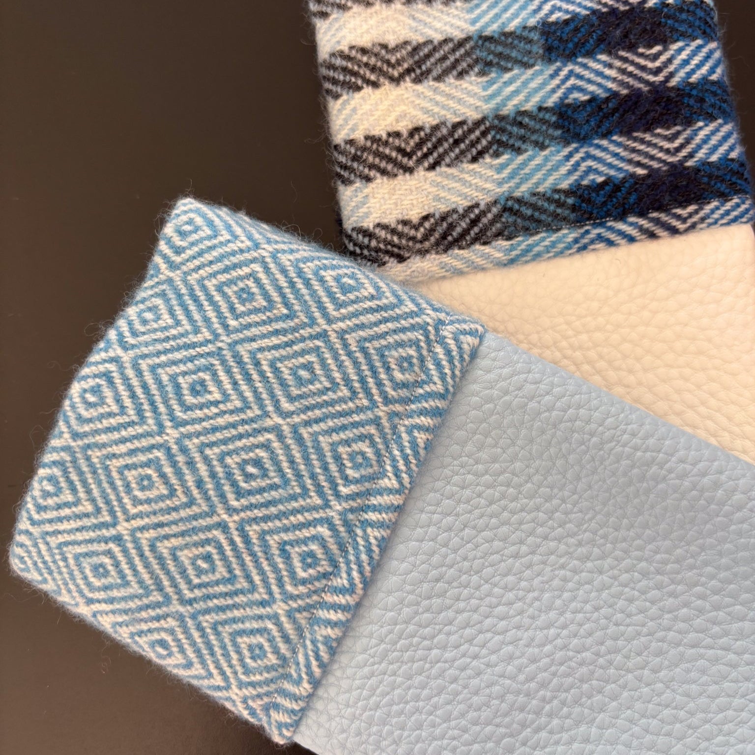 Three fabric swatches with different patterns and colors on a dark background