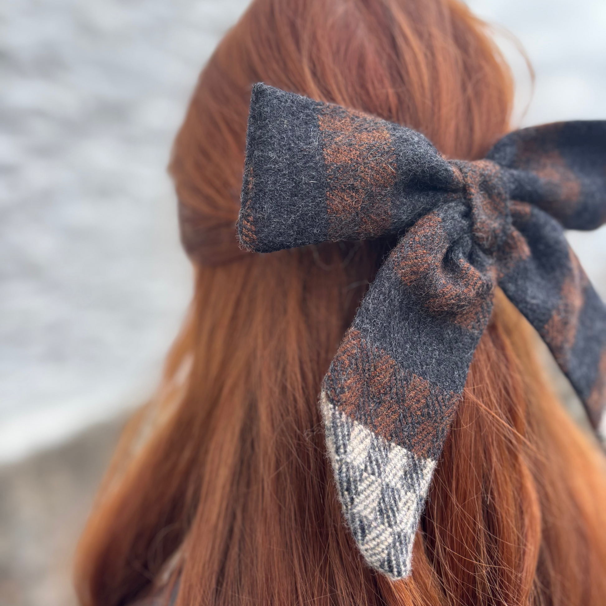 Irish tweed hair bow on red hair with a blurred background