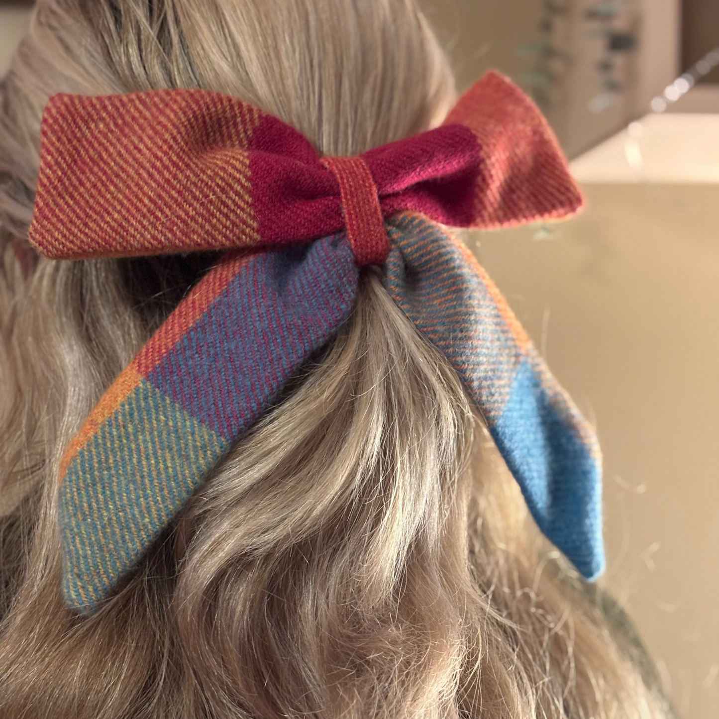 Colorful bow in a person's hair with a blurred background
